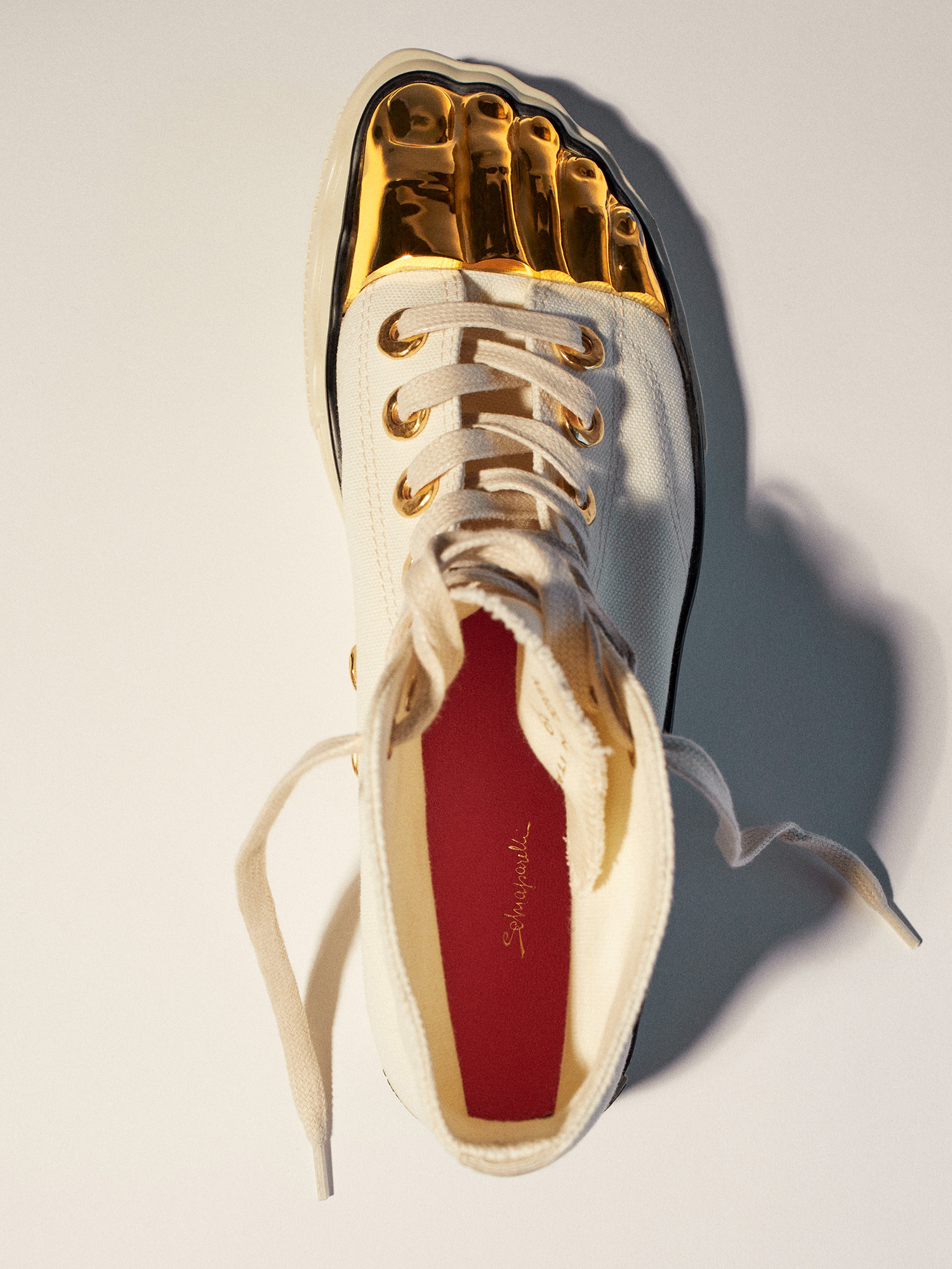 Schiaparelli debuts "Gold Toe Trainers," its first-ever sneaker